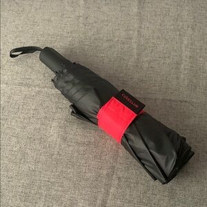 Black Compact Umbrella with Red Strap and Curved Handle
